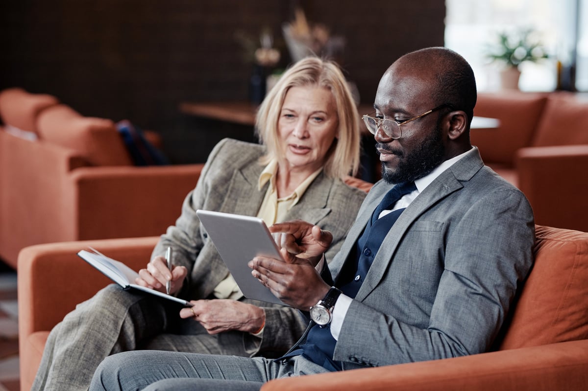 FOYI advisor walking a business owner through their growth plan on a tablet