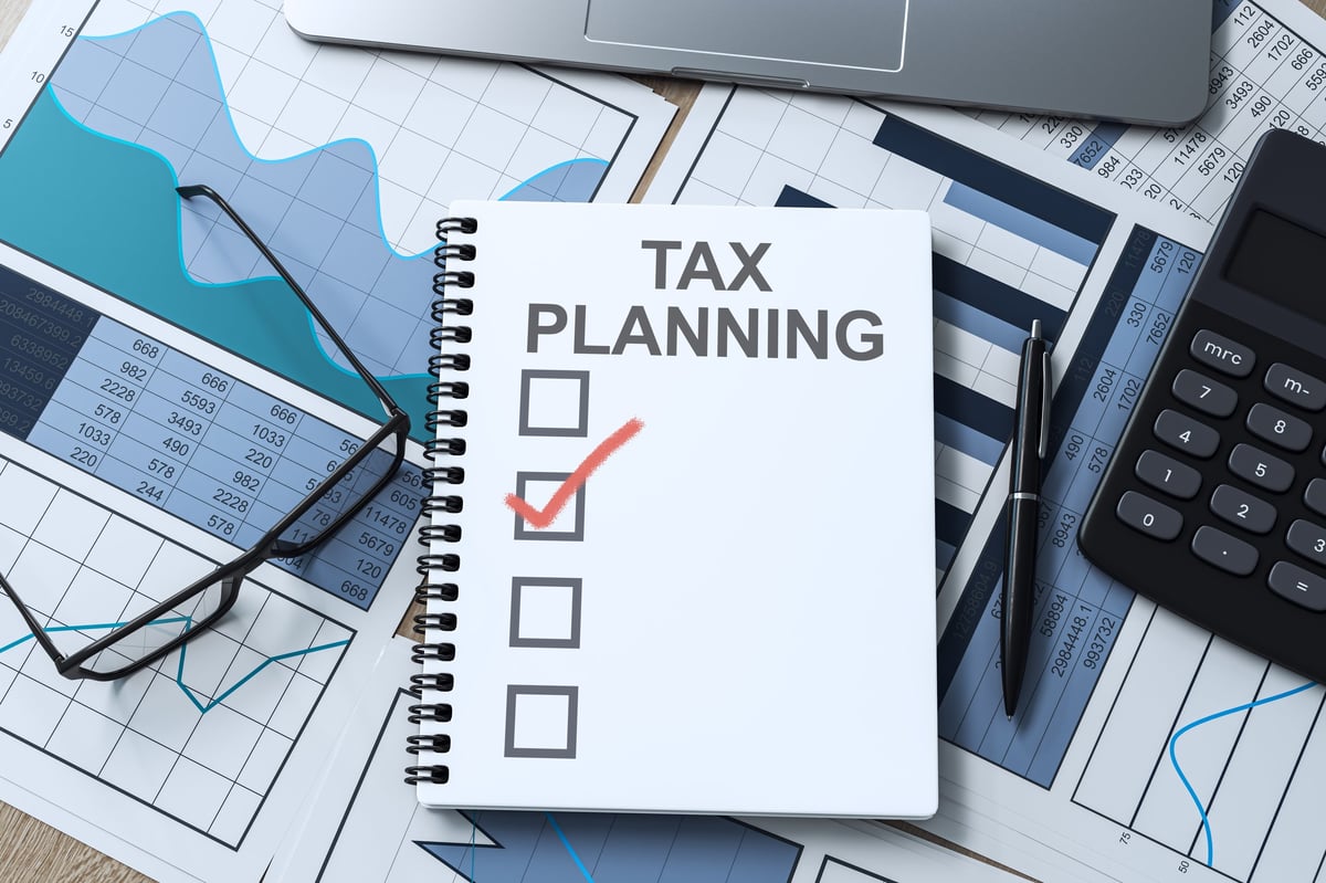 Tax planning checklist and business records organized on a desk
